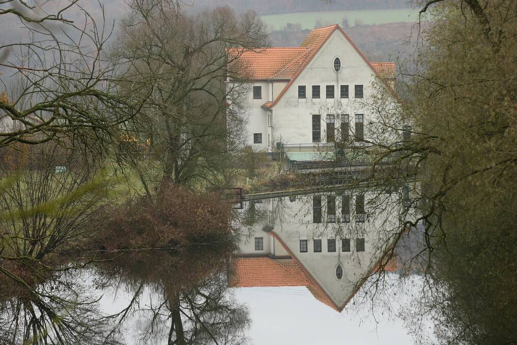 A house stands reflected in a river on November 19, 2012 in Wuelmersen, Germany. Photo by Sean Gallup/Getty Images