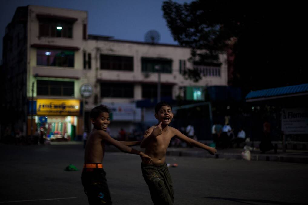 Two boys celebrate scoring a goal during a game of street soccer on February 10, 2013 in Yangon, Burma. Photo by Chris McGrath/Getty Images