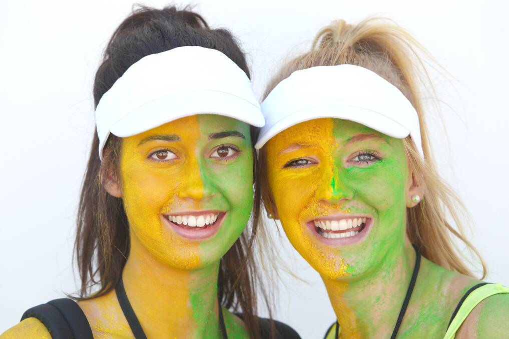 Fans painted in Australian colors pose during day two of the 2013 Australian Open. Photo by Marianna Massey/Getty Images