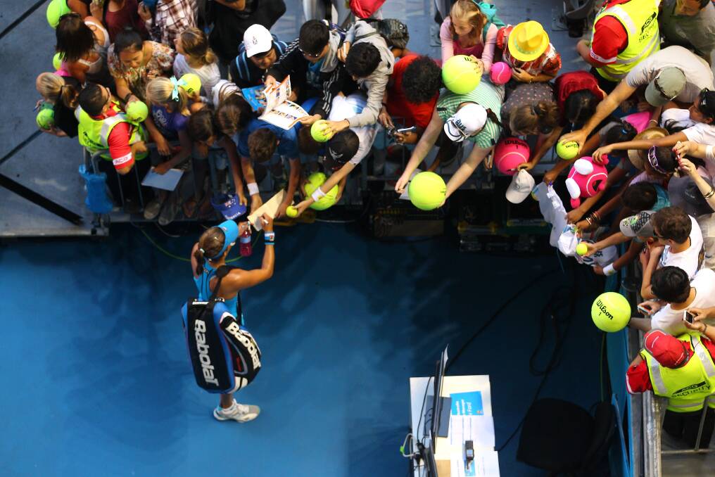 Julia Goerges of Germany signs an autograph after losing her fourth round match against Na Li. Photo by Scott Barbour/Getty Images