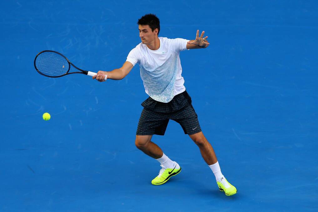 Bernard Tomic of Australia plays a forehand in his first round match against Leonardo Mayer of Argentina during day two of the 2013 Australian Open. Photo by Quinn Rooney/Getty Images