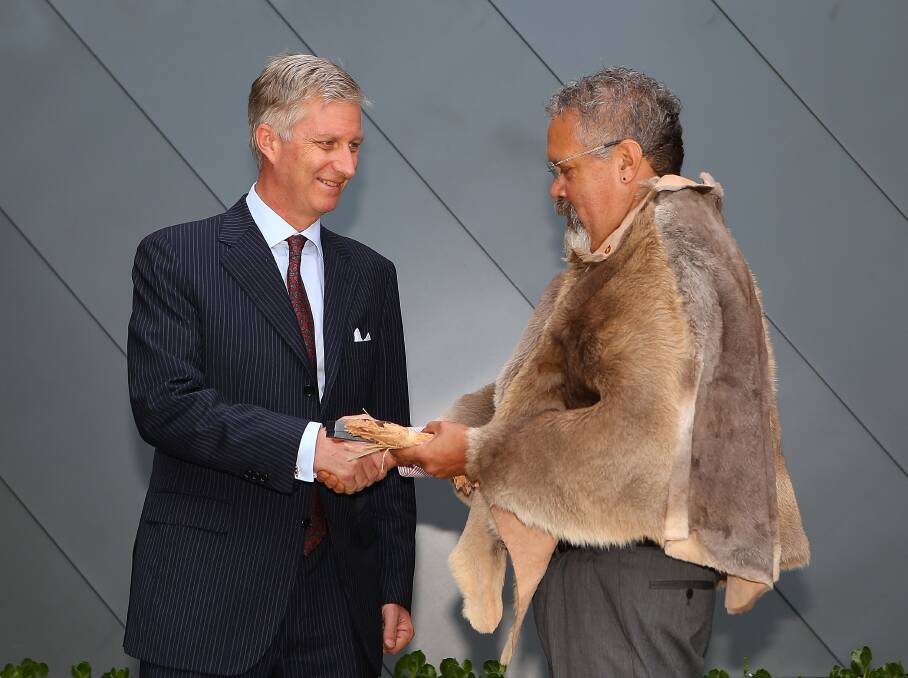 HRH Prince Philippe and Belgium receives a gift from Aboriginal elder Associate Professor Simon Forrest after being welcomed with a smoking ceremony at Curtin University in Perth, Australia. Photo by Paul Kane/Getty Images