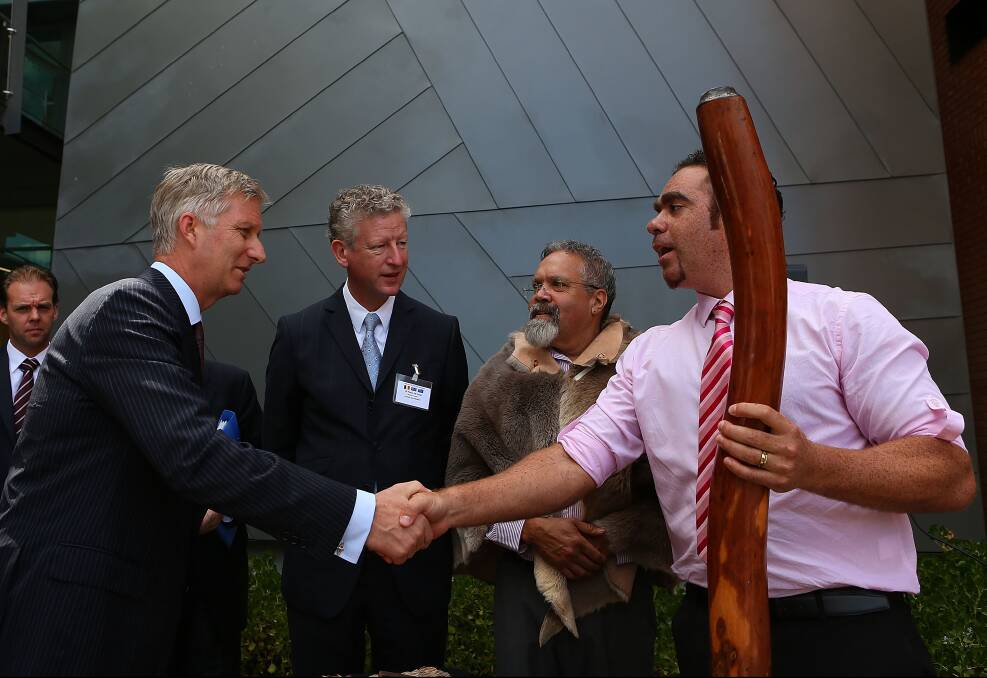 HRH Prince Philippe and Belgian Minister of Defence HE Me Pieter De Crem, talk with Aboriginal elder Associate Professor Simon Forrest and Andrew Beck (R) after being welcomed with a smoking ceremony at Curtin University in Perth, Australia. Photo by Paul Kane/Getty Images