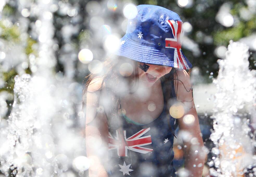 A young girl plays in the fountain in Garden Square during day two of the 2013 Australian Open. Photo by Marianna Massey/Getty Images