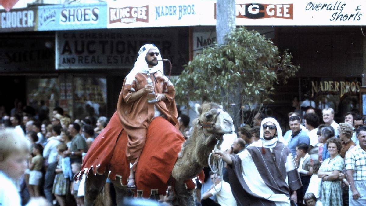 Michel Nader riding a camel at the Moruya Mardi Gras in the 1970s