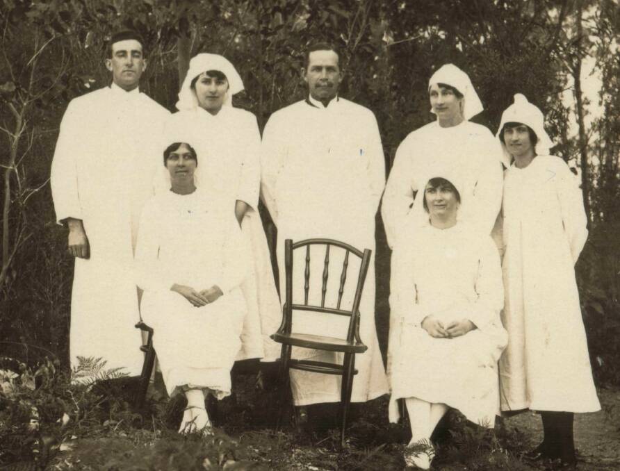 VOLUNTEERS IN 1919: Narooma School of Arts was converted into an emergency hospital manned by Volunteer Aid Detachments (VADs). Shown are Amy Verent (nee Woollett), front left; Cyril Fuller, back left, Queenie Fuller, Mr Hansen, Queenie Costin, Ettie and Lottie Fuller (seated right). Hansen's son Hilary believes the empty chair represents Mrs Dawson Hansen, Hansen's first wife, who died while nursing at the emergency hospital. Photo courtesy Stella Costin and Narooma Historical Society.