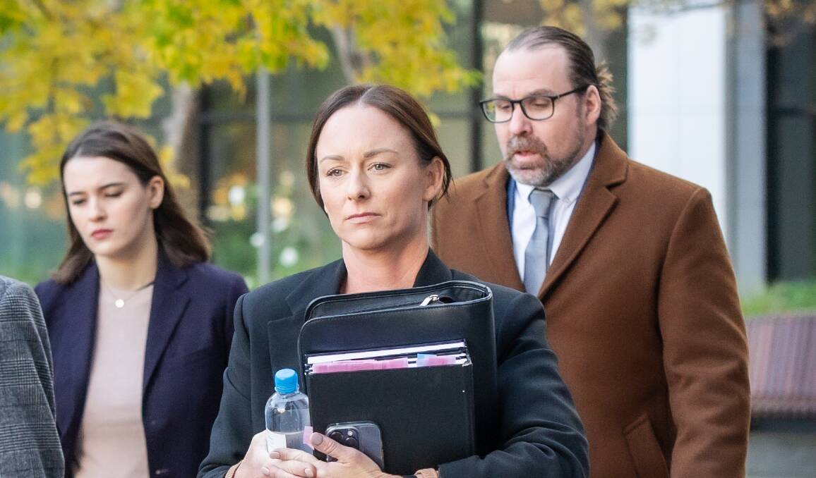 Senior Constable Emma Frizzell, centre, outside the inquiry. Picture by Karleen Minney
