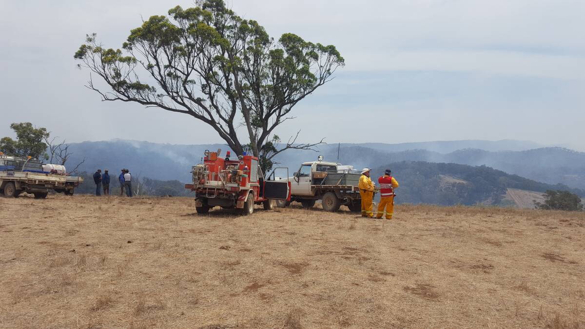 NSW RFS crews at Bill Alders’ property, Inverness, overlooking the gully where the fire has taken off this afternoon. Photo: supplied. 