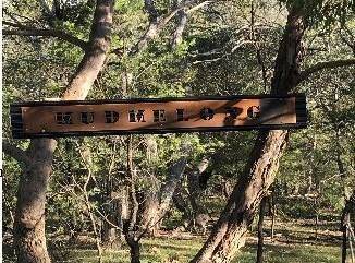 GIFT: A heavy three metre long sign, mounted over three metres high, has been stolen from a property in Araluen. Photo: supplied. 