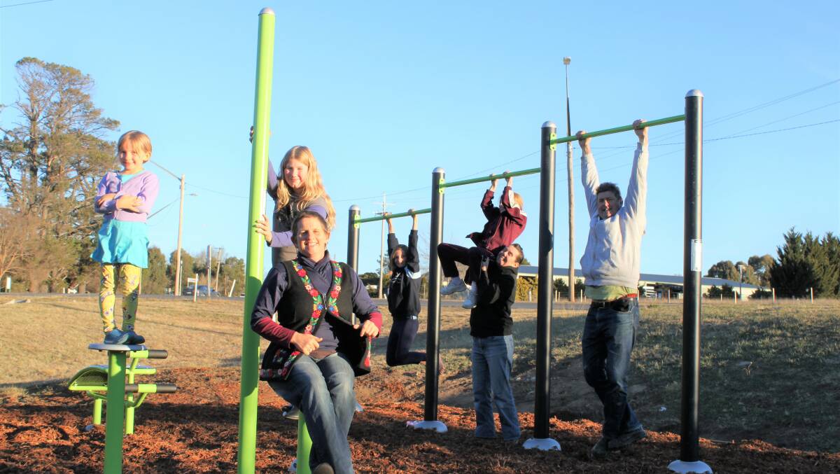 Annie Duke (front), Donna and Peter Hazell (second right and far right) and Bridie, River, Romany and Rosalie try out the new outdoor gym on Bombay Road.