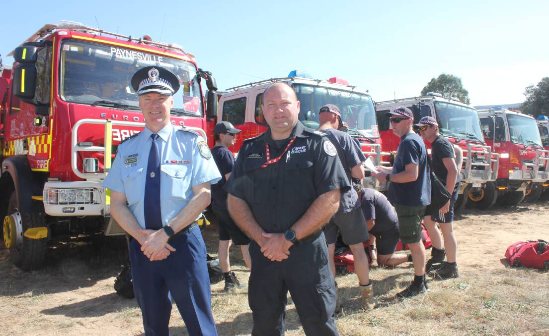 NSW Police Academy superintendent Rod Smith and CFA Commander Steve Alcock with some of the many Victorian firefighters getting ready for the day in Goulburn. Photo David Cole. 