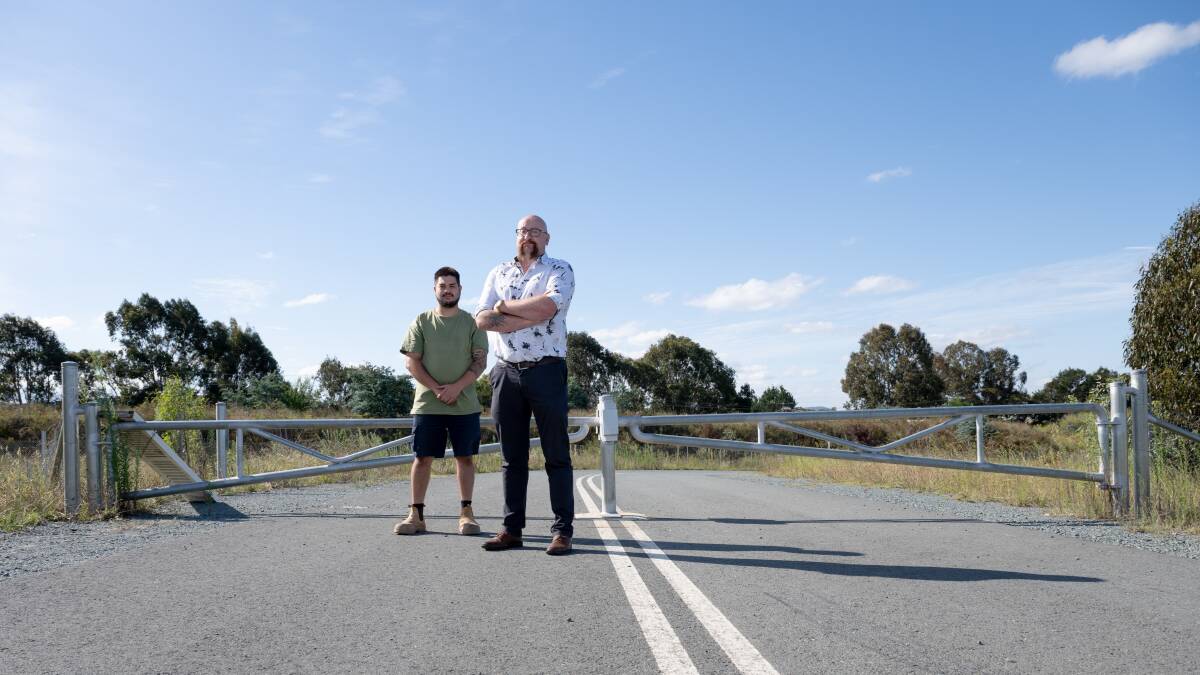 South Jerrabomberra's Ray Brown with Phil Luke at a locked gate on Territory Parade in NSW that is closed to accessing the ACT. Picture by Elesa Kurtz