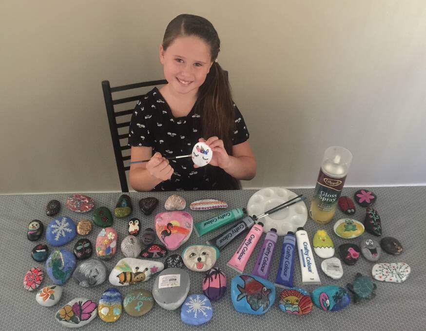 Kyra, 9, loves painting rocks to raise awareness of ovarian cancer.