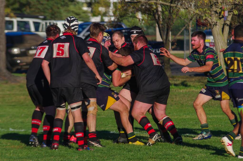 Swarmed: The Redbacks envelop a Bungendore player in the course of their 24-15 defeat at the hands of the Mudchooks on Saturday afternoon at Bungendore's Mick Sherd Oval. Photo: Gordon Waters.