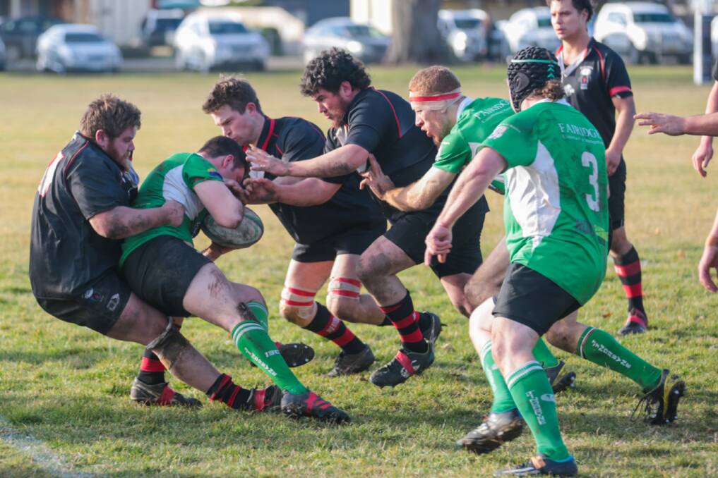 Team effort: Braidwood works together to haul a Jindabyne player into a tackle on the weekend, as the Redbacks ran out winners over the finals contenders at the Rec Grounds. Photo: Gordon Waters.