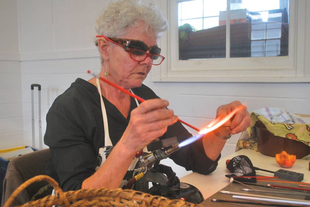 PLAYING WITH FIRE: Lampwork is like zen for glassmaker Kerry Mitchell.