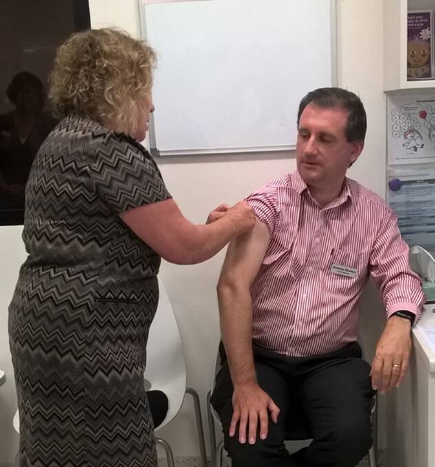 VACCINATION: SNSWLHD Chief Executive Andrew Newton has received his flu vaccination at South East Regional Hospital. Photo: SNSWLHD.