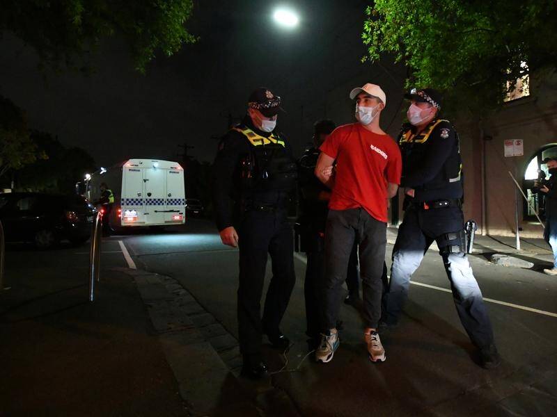 Police detain a Tigers supporter before releasing him on Swan Street in Richmond, Melbourne.