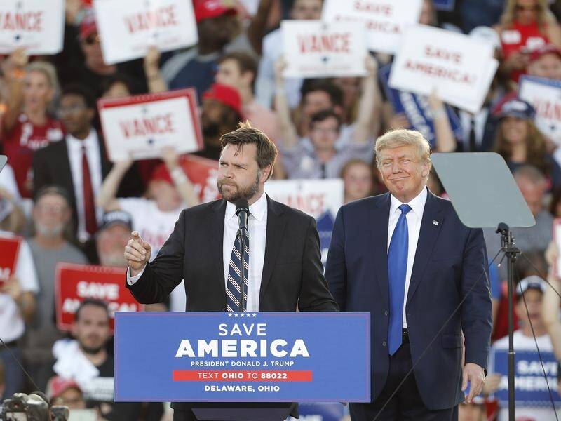 Former US president Donald Trump has thrown his weight behind Ohio Senate candidate J.D. Vance (l).