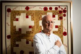 Richard Reid in front of a quilt given him to commemorate his work as a historian. Picture by Elesa Kurtz