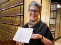 National Library of Australia director-general Marie-Louise Ayres with one of the millions of handwritten manuscripts. Picture by Elesa Kurtz