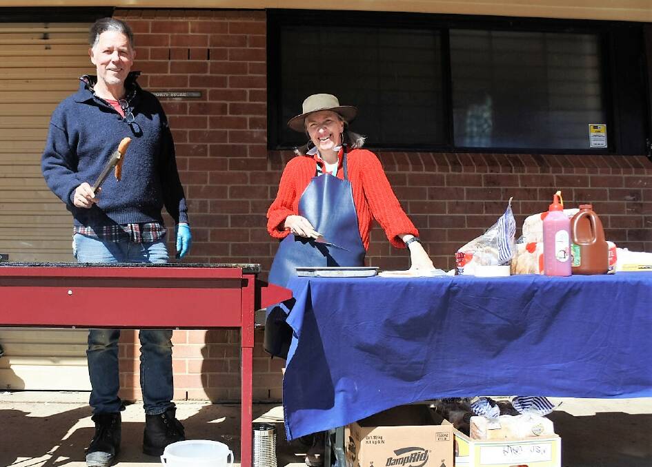 John Stahel and Pauline Webber get the democracy sausage sizzle going at Braidwood Central School.