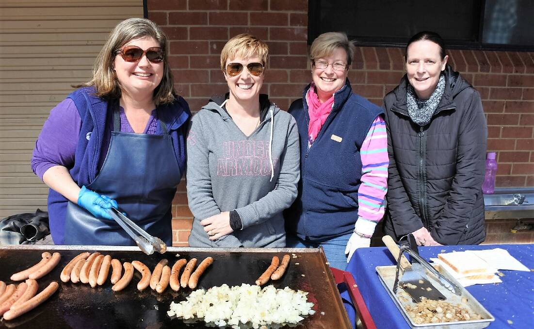 Chris Campbell, Sharon Blinco, Corinne Howard and Kirshley Julienne woman the barbeques at Braidwood Central School.