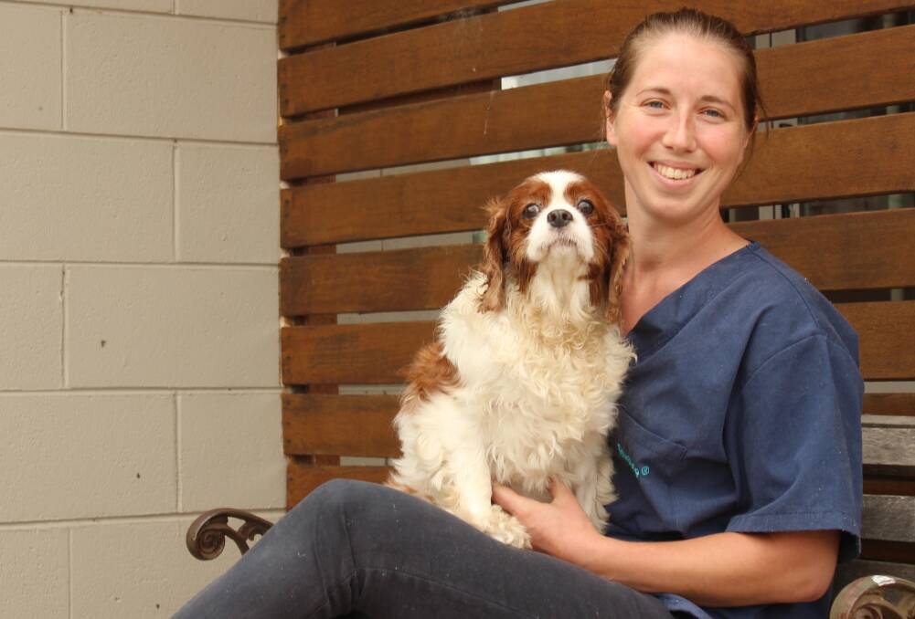 NEW FACE: Morgan Benny at Braidwood Vet Surgery, with the surgery dog. The new vet grew up on a small property with lots of animals. Photo: Elspeth Kernebone