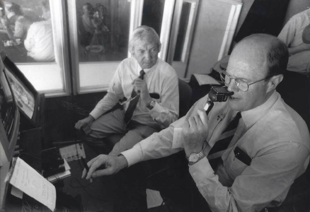 Richie Benaud and Tony Greig (right) at work for Channel 9 at the Melbourne Cricket Ground.
