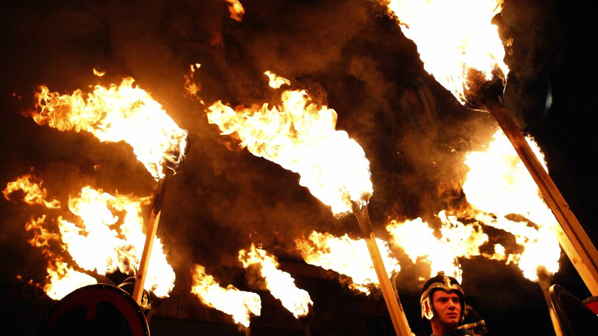 Up Helly Aa vikings from the Shetland Islands, hold lit torches during the annual torchlight procession to mark the start of Hogmanay (New Year) celebrations in Edinburgh, Scotland. Photo: REUTERS