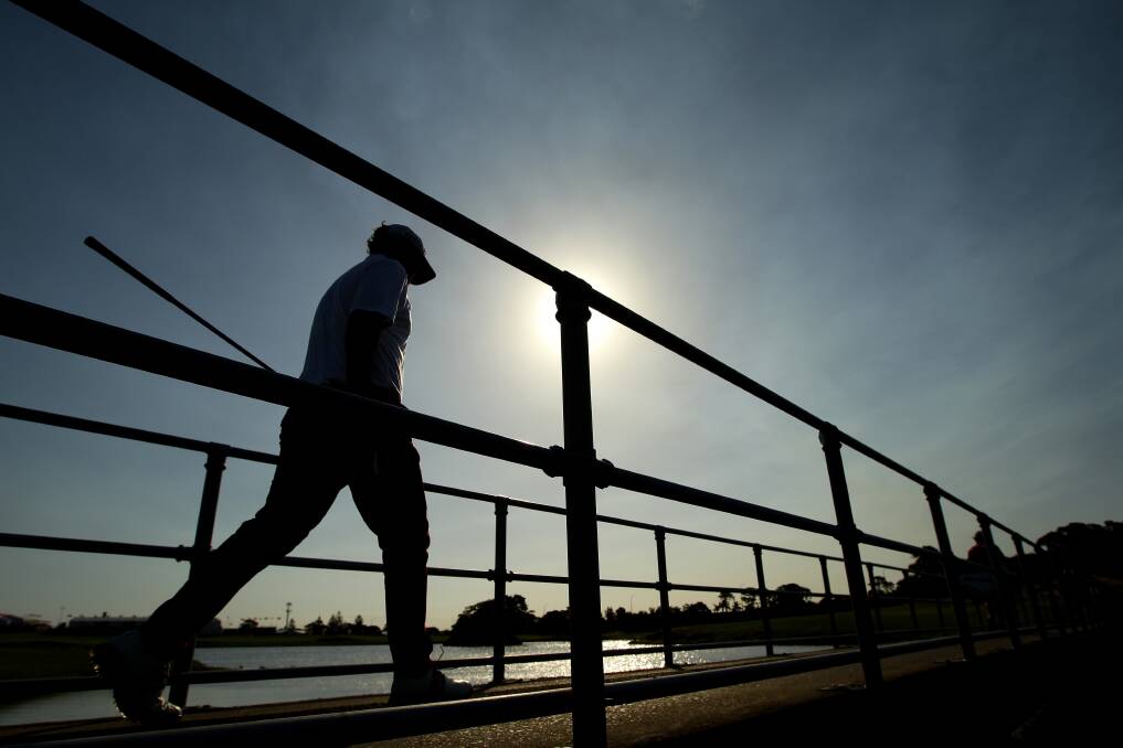 Marcus Fraser of Australia walks across a footbridge during round one of the 2012 Australian Open at The Lakes Golf Club in Sydney, Australia. Photo by Matt King/Getty Images