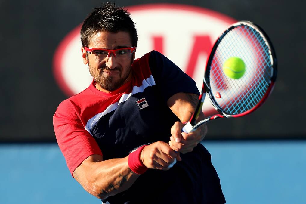Janko Tipsarevic of Sebia plays a backhand in his second round match against Lukas Lacko of Slovakia. Photo by Chris Hyde/Getty Images