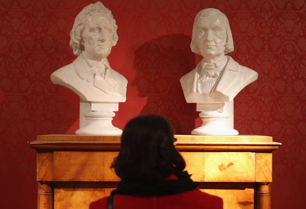 A museum administration employee looks at busts of brothers Jacob and Wilhelm Grimm at the Grimm Brothers Museum in Kassel, Germany. Photo by Sean Gallup/Getty Images