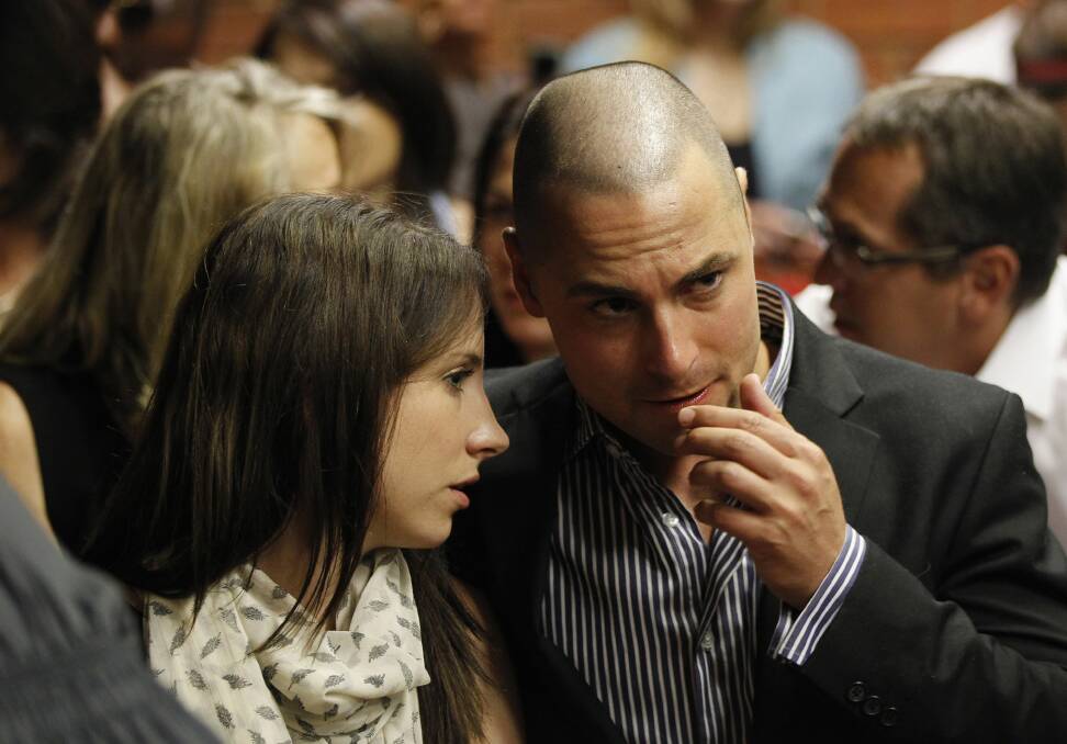 Oscar Pistorius's sister Aimee and brother Carl await the start of court proceedings in the Pretoria Magistrates court, February 19, 2013. Photo: REUTERS/Siphiwe Sibeko