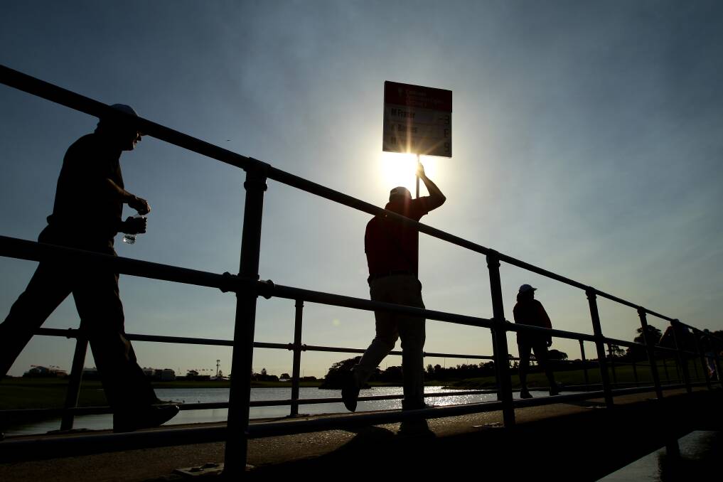 An official walks across a footbridge during round one of the 2012 Australian Open at The Lakes Golf Club in Sydney, Australia. Photo by Matt King/Getty Images