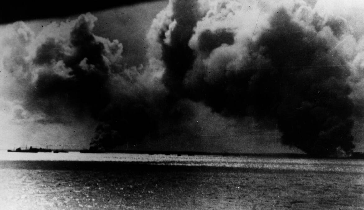 Smoke rises from the area of Port Darwin after the Japanese raid. Allied ships are ablaze, and much damage was done on this surprise attack. Photo by Keystone/Getty Images