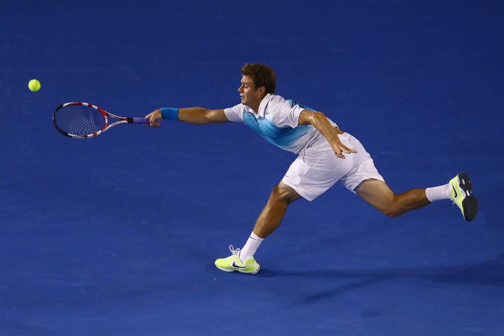 Ryan Harrison of USA stretches for a forehand in his second round match against Novak Djokovic of Serbia. Photo by Mark Kolbe/Getty Images