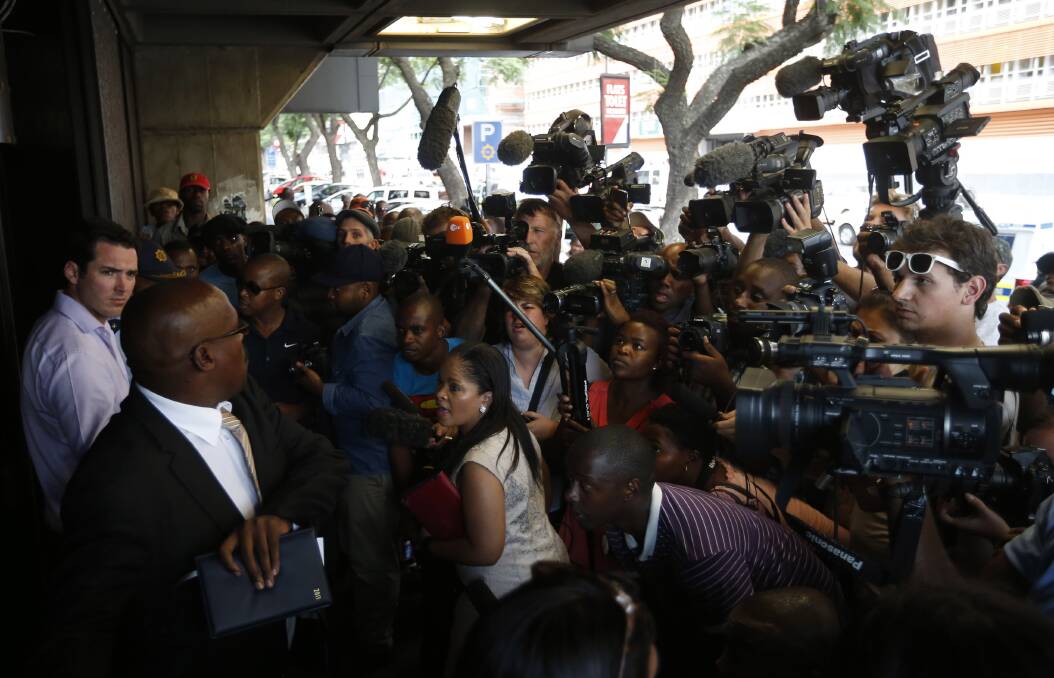 Journalists wait outside the Pretoria Magistrates court during the bail application of "Blade Runner" Oscar Pistorius February 19, 2013. Photo: REUTERS/Mike Hutchings