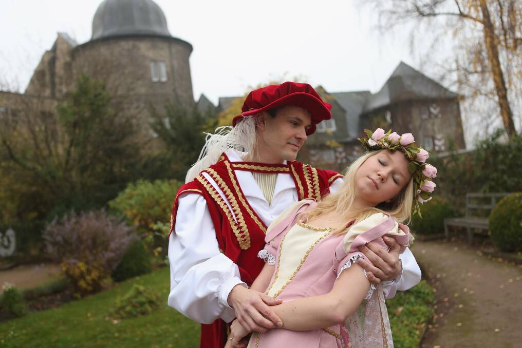 Prince Charming, actually actor Andreas Richhardt, supports Sleeping Beauty, played by actress Elisabeth Knoche, at Sababurg Palace near Hofgeismar, Germany. Photo by Sean Gallup/Getty Images