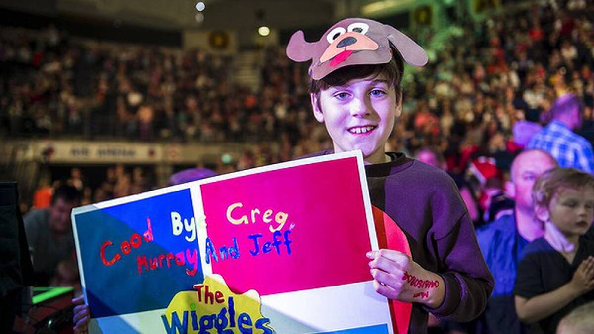 The Wiggles perform at AIS Arena. Elliot Cleaves (11), dressed as Wags with his Goodbye poster. Photo: Rohan Thomson