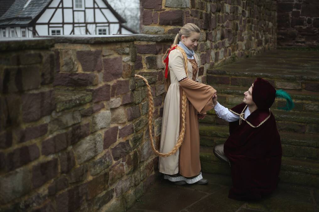 Rapunzel, actually 13-year-old actress Anna Helver, greets her prince, played by actor Daniel Stuebe, on a rampart of Trendelburg Castle in Trendelburg, Germany. Photo by Sean Gallup/Getty Images