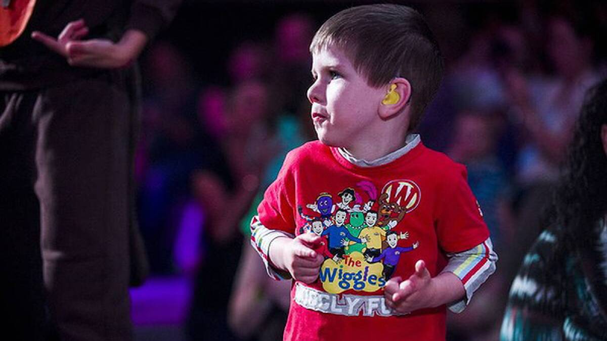 The Wiggles perform at AIS Arena. Liam Denny (4) dances at the front. Photo: Rohan Thomson