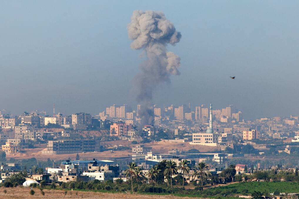 A plume of smoke rises over Gaza during an Israeli air strike, as seen from Sderot in Israel. A rocket attack on an apartment building in Kiryat Malachi, Israel earlier claimed three lives, some 24 hours after the IDF targeted nearly 200 sites in the Gaza Strip, killing Ahmed Jabari, a top military commander of Hamas, in the process. Photo by Uriel Sinai/Getty Images