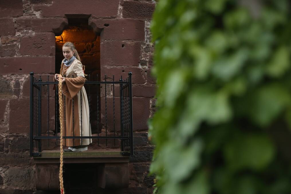 Rapunzel, actually 13-year-old actress Anna Helver, lets down her hair from a tower balcony of Trendelburg Castle to her prince in Trendelburg, Germany. Photo by Sean Gallup/Getty Images