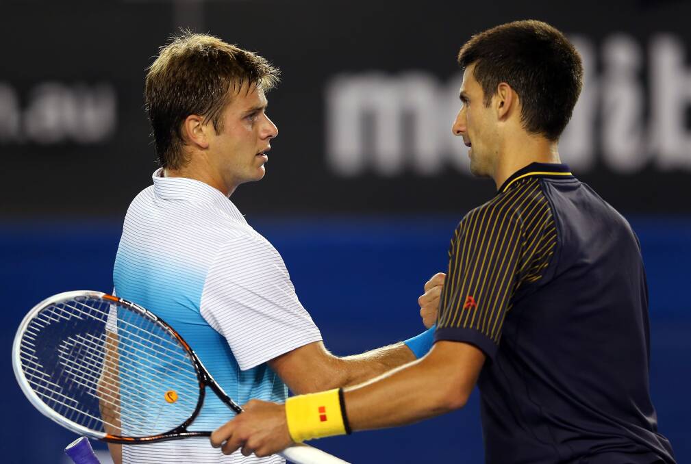 Novak Djokovic of Serbia shakes hands with Ryan Harrison of USA after their second round match. Photo by Julian Finney/Getty Images
