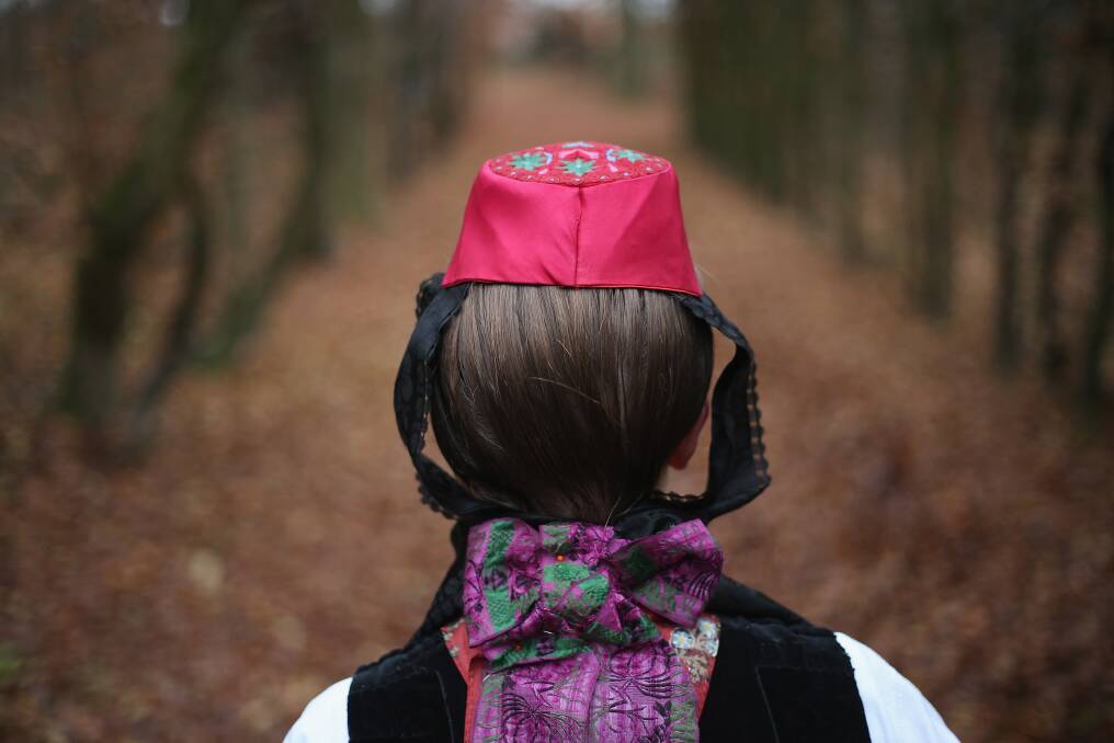 Little Red Riding Hood, actually actress Dorothee Weppler, wears the local Schwalm region folk dress with its red cap as she walks through a forest on the estate of Baron von Schwaerzel in Willingshausen, Germany. Photo by Sean Gallup/Getty Images