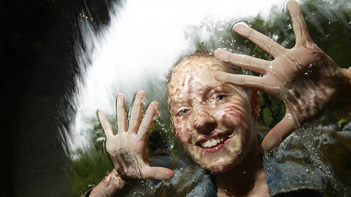 Opening of the National Gallery of Victoria.13-year-old Bethany England of Hawthorn tries the water wall which she helped former Premier Jeff Kenett turn off four years ago. December 4, 2003. Photo: Paul Harris