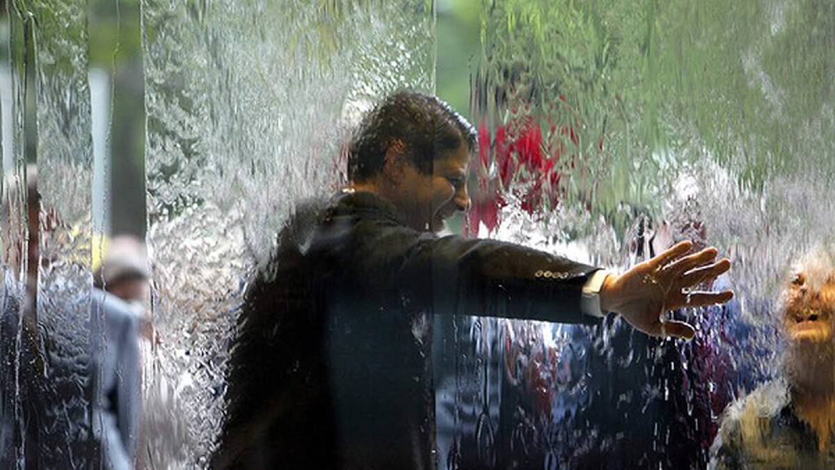 Opening of the National Gallery of Victoria. Premier Steve Bracks tests out the water wall. December 4, 2003. Photo: Paul Harris